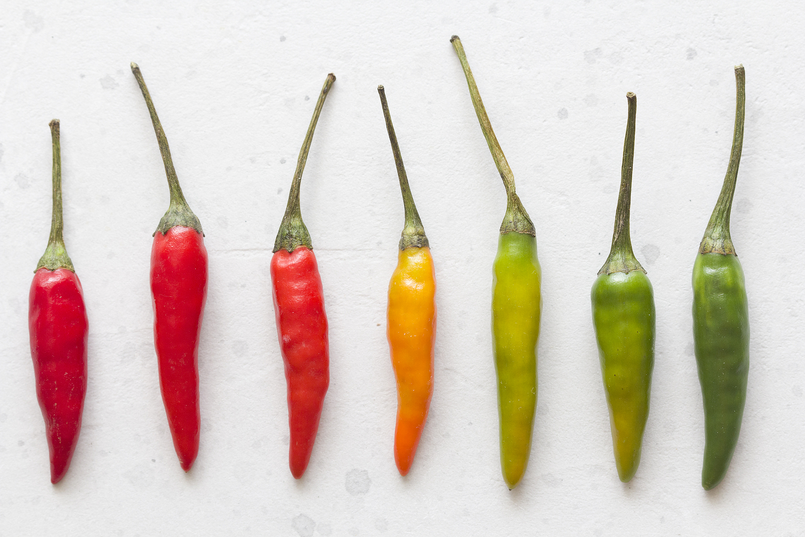 Red Hot Chili Peppers On Background Or White Table. A Lot Of Red
